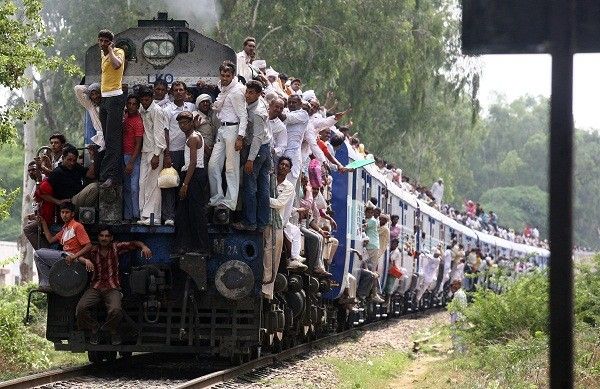 Hindu devotees travel in an overcrowded passenger train after taking a holy dip and offering prayers in the waters of Brahma Sarovar, a sacred pond, during a solar eclipse city  Kurukshetra July 22, 2009-Reuters.jpg